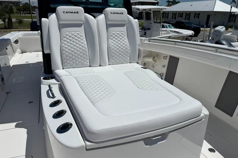 Slide: The Image of 2026 Caymas 34 CT boat with luxurious white seating and cup holders. - 11