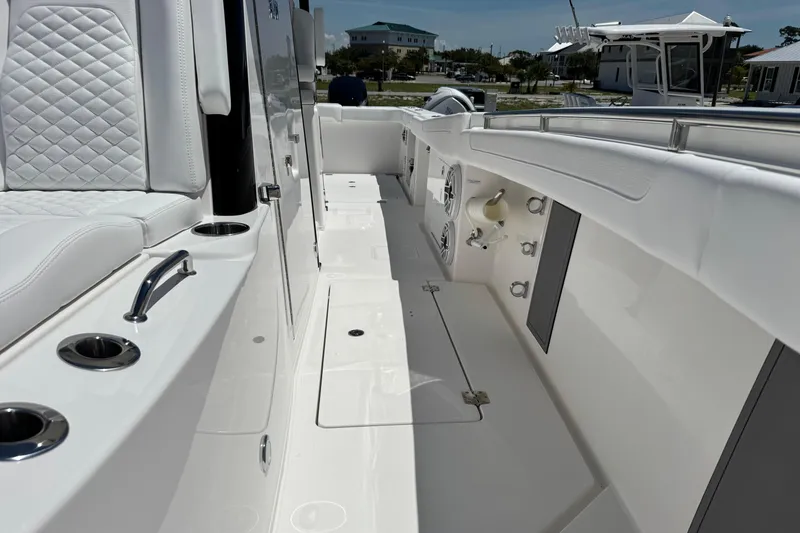 Slide: The Image of 2026 Caymas 34 CT boat interior with white seating and stainless steel fixtures. - 14