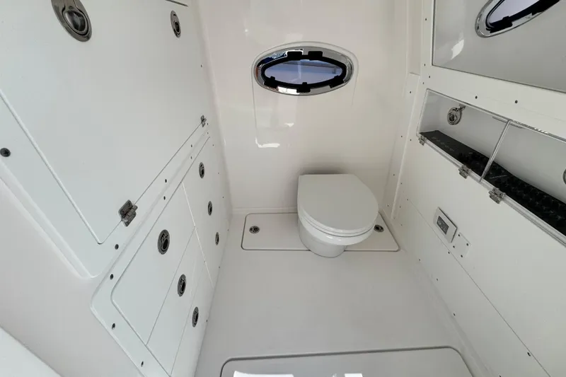 Slide: The Image of 2026 Caymas 34 CT boat bathroom with modern white interior and compact design. - 15