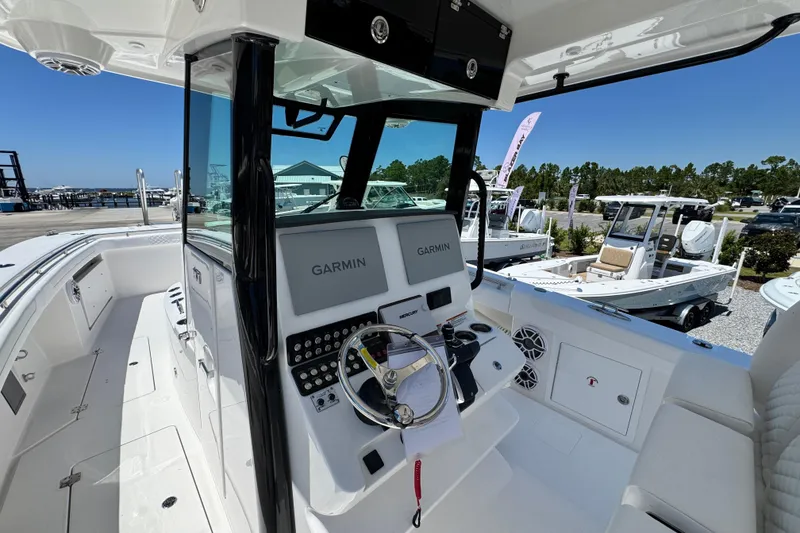 Slide: The Image of 2026 Caymas 34 CT boat interior with Garmin navigation system at marina. - 16