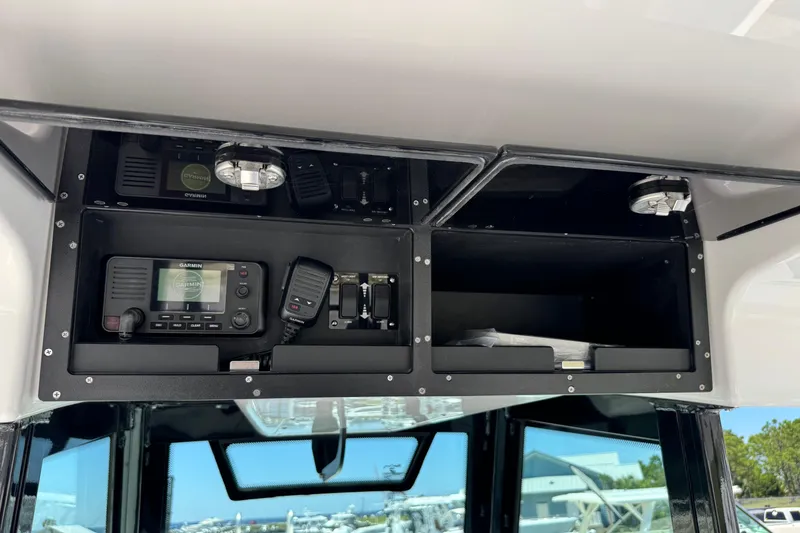 Slide: The Image of 2026 Caymas 34 CT boat dashboard with Garmin navigation and communication equipment. - 19