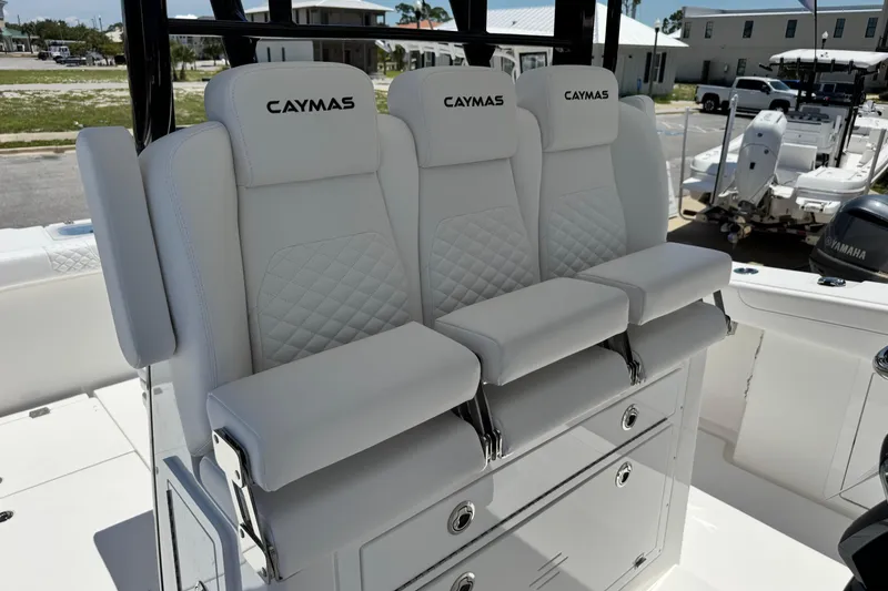 Slide: The Image of 2026 Caymas 34 CT boat with luxurious white seating and storage compartments. - 21