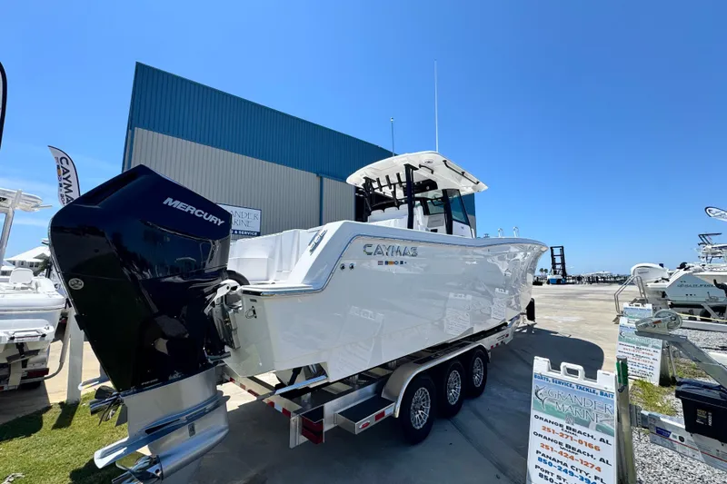 Slide: The Image of 2026 Caymas 34 CT boat with Mercury engine on trailer at marina. - 3
