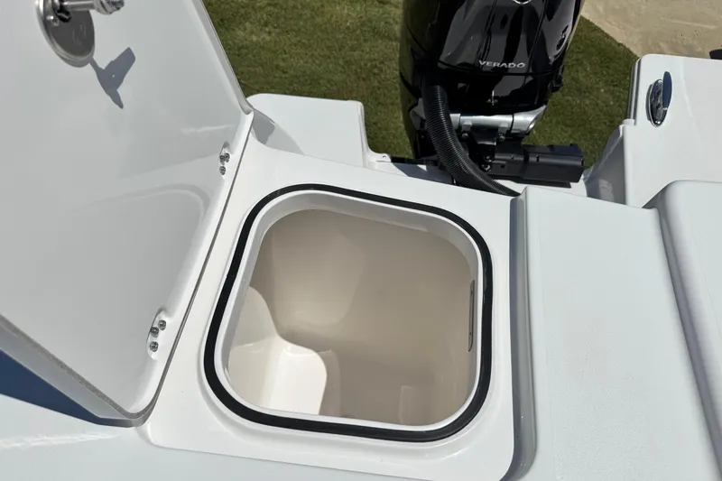 Slide: The Image of Open storage compartment on 2026 Caymas 34 CT boat, with Verado engine visible. - 35