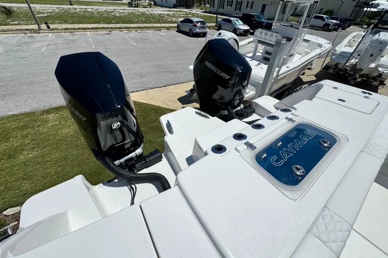 Slide: The Image of 2026 Caymas 34 CT boat with dual Mercury outboard engines in a parking area. - 36
