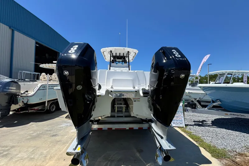 Slide: The Image of 2026 Caymas 34 CT boat with dual outboard engines in a marina setting. - 4