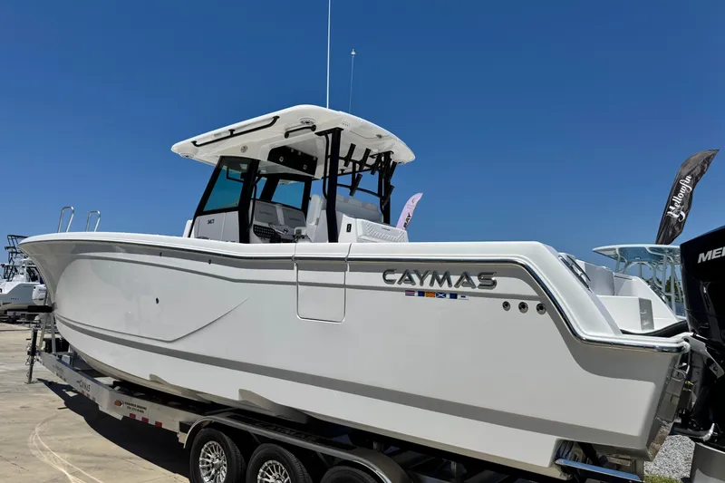 Slide: The Image of 2026 Caymas 34 CT boat on trailer under clear blue sky. - 5