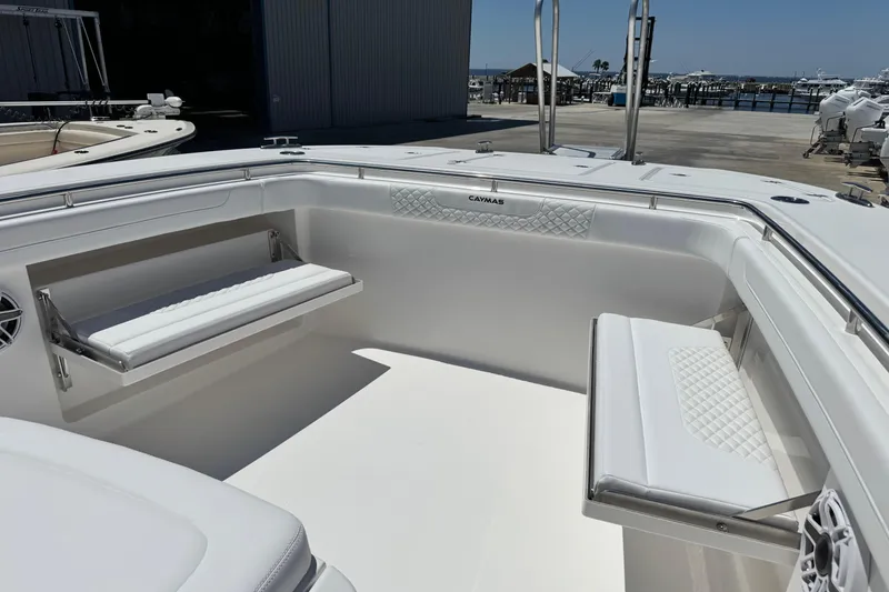 Slide: The Image of 2026 Caymas 34 CT boat interior with white seating and dockside view. - 9
