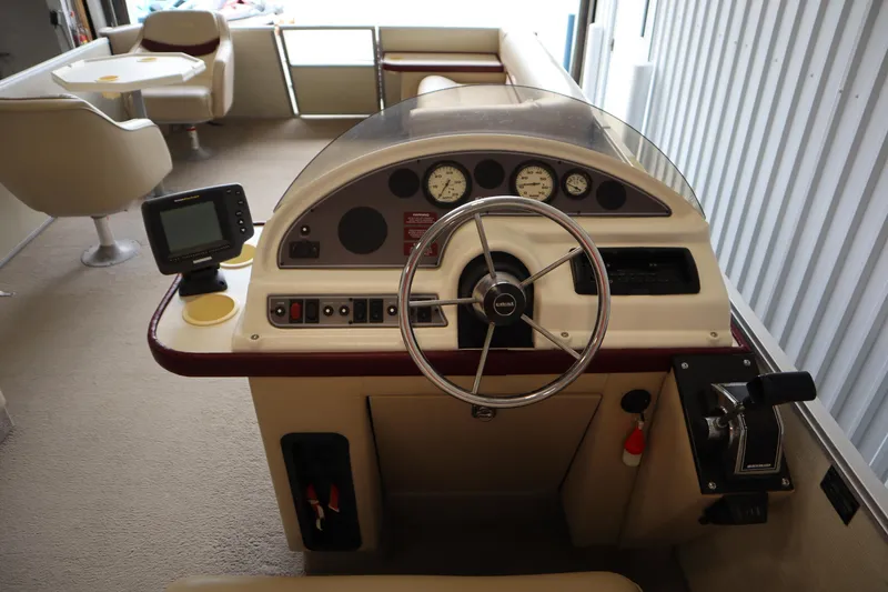 Slide: The Image of 1997 Crest 25 Caribbean boat interior with steering wheel and control panel. - 12