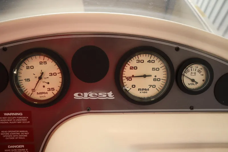 Slide: The Image of Dashboard of a 1997 Crest 25 Caribbean boat with speedometer, RPM, and voltmeter gauges. - 15