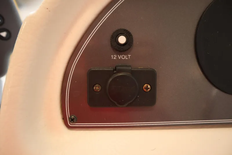Slide: The Image of 12-volt outlet on 1997 Crest 25 Caribbean boat dashboard. - 16