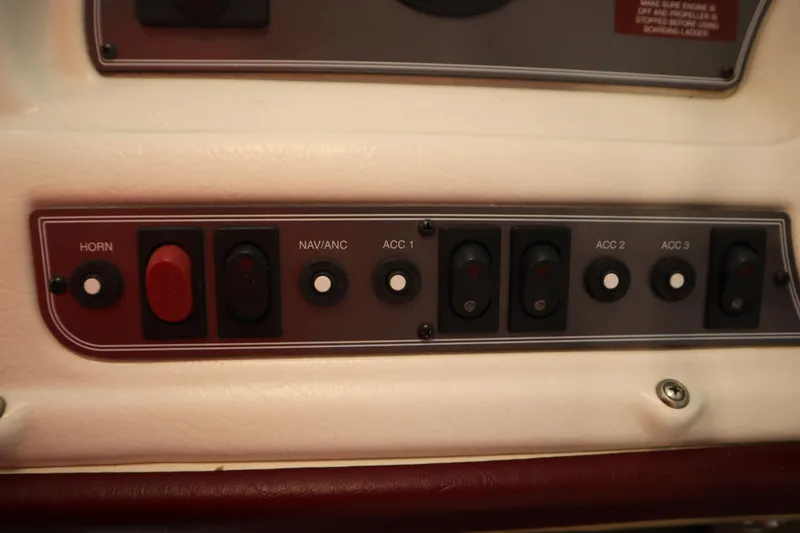 Slide: The Image of Control panel of a 1997 Crest 25 Caribbean boat with labeled switches. - 17