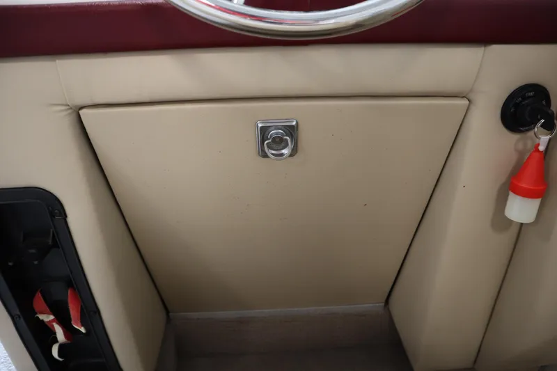 Slide: The Image of 1997 Crest 25 Caribbean boat dashboard with key and storage compartment. - 20