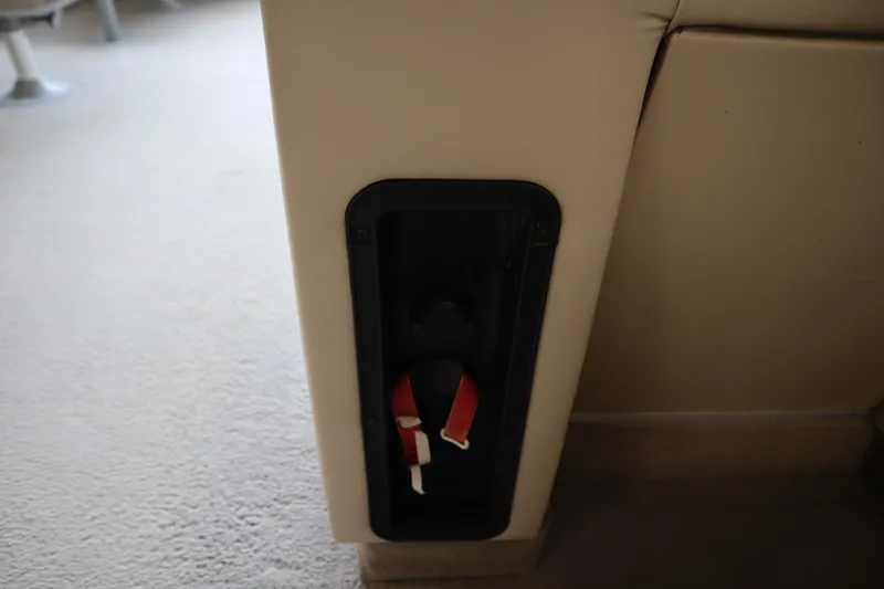 Slide: The Image of Interior detail of a 1997 Crest 25 Caribbean boat, featuring a built-in storage compartment. - 21