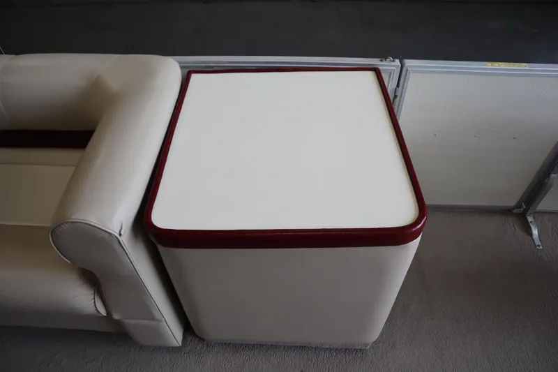 Slide: The Image of 1997 Crest 25 Caribbean boat interior with beige seating and red-trimmed table. - 23