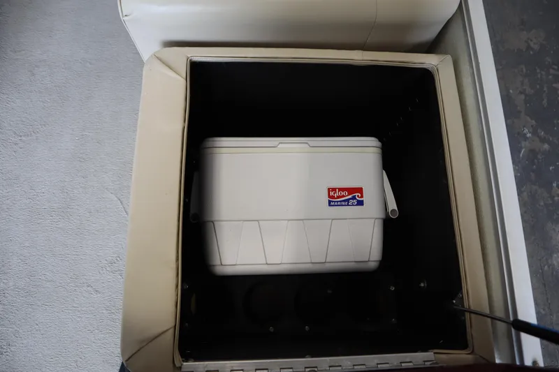 Slide: The Image of White Igloo Marine 25 cooler inside a 1997 Crest 25 Caribbean boat compartment. - 24