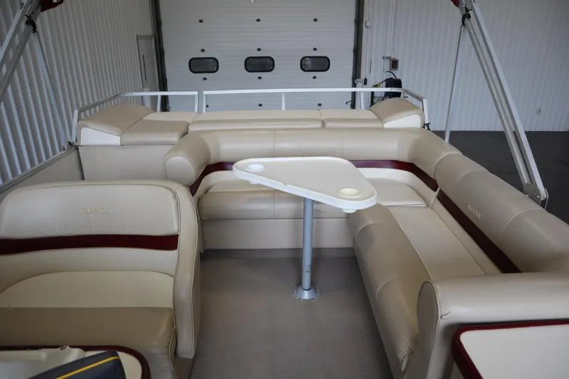 Slide: The Image of 1997 Crest 25 Caribbean boat interior with beige seating and a central table. - 25