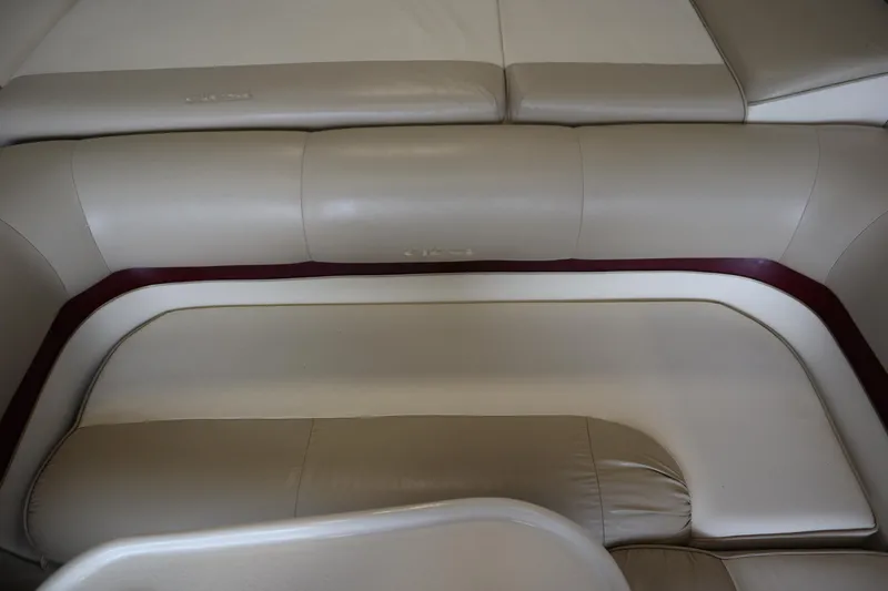 Slide: The Image of 1997 Crest 25 Caribbean boat interior with beige leather seating and maroon accents. - 27
