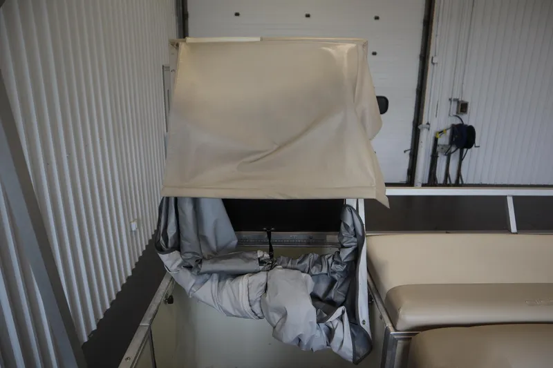 Slide: The Image of 1997 Crest 25 Caribbean boat interior with beige canopy in storage. - 30
