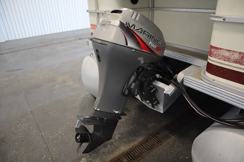 Slide: The Image of 1997 Crest 25 Caribbean boat with Mariner outboard motor in a garage setting. - 32