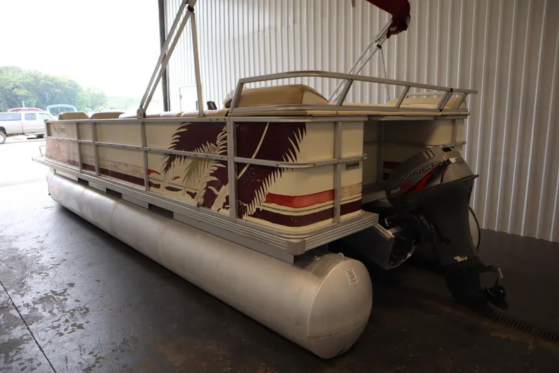 Slide: The Image of 1997 Crest 25 Caribbean pontoon boat with Mariner outboard motor in storage. - 4