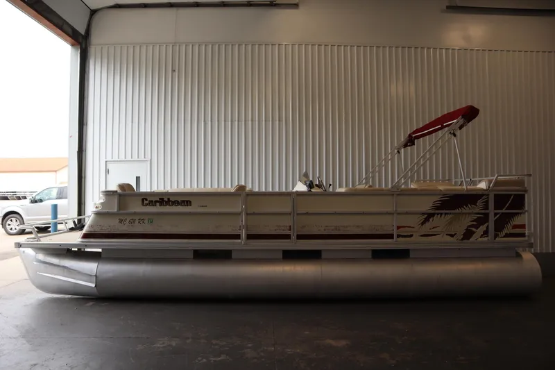 Slide: The Image of 1997 Crest 25 Caribbean pontoon boat with canopy in a storage facility. - 5