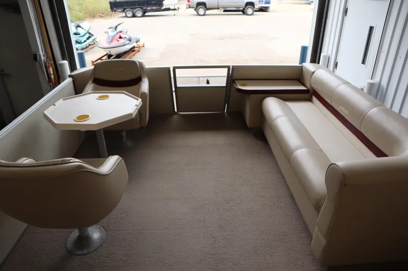 Slide: The Image of Interior of a 1997 Crest 25 Caribbean boat with beige seating and table. - 7