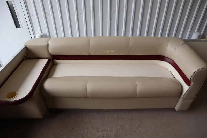 Slide: The Image of Beige and maroon seating on 1997 Crest 25 Caribbean boat, with integrated cup holder. - 9