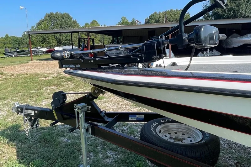Slide: The Image of 2000 Bullet 21XD boat on trailer with MotorGuide trolling motor in outdoor setting. - 2