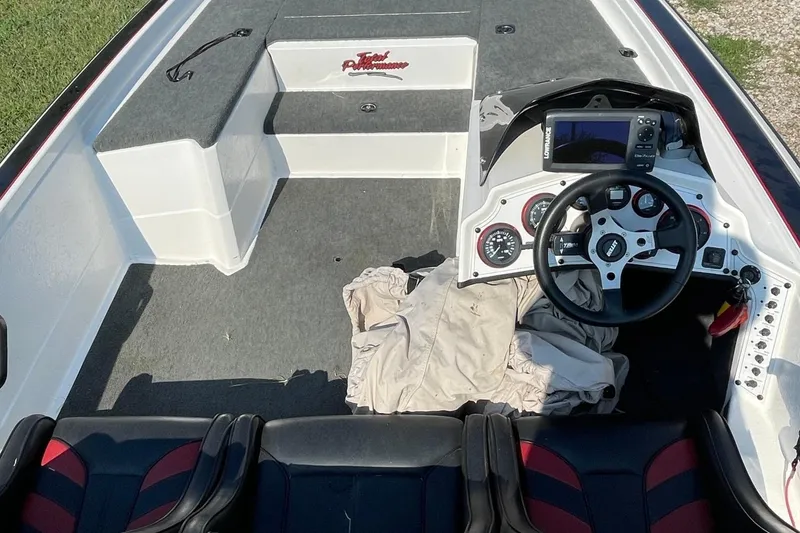 Slide: The Image of Interior of a 2000 Bullet 21XD boat with steering wheel and navigation system. - 3