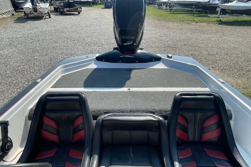 Slide: The Image of 2000 Bullet 21XD boat interior with black and red seats, outdoor setting. - 4