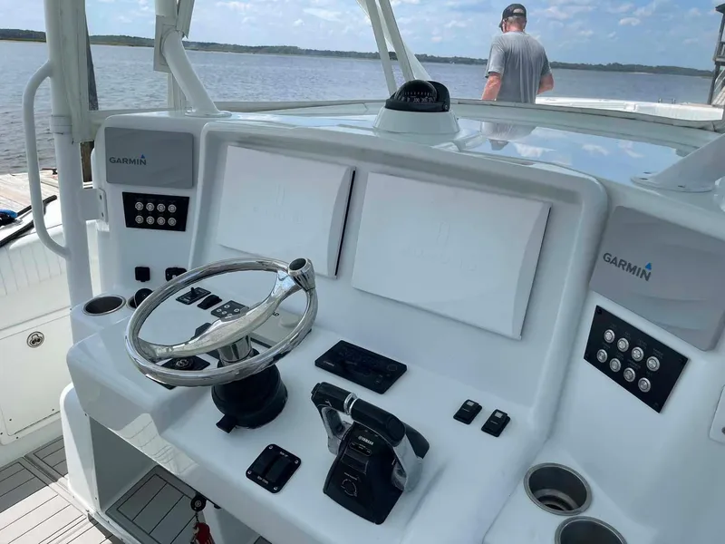 Slide: The Image of 2014 Yellowfin 42 boat helm with Garmin navigation, steering wheel, and control panel. - 10