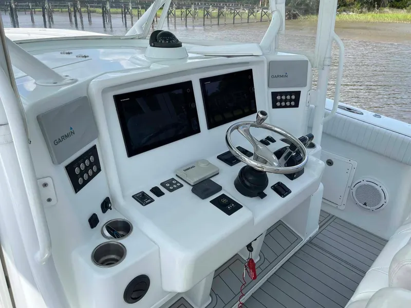 Slide: The Image of Control panel of a 2014 Yellowfin 42 boat with Garmin navigation systems. - 11