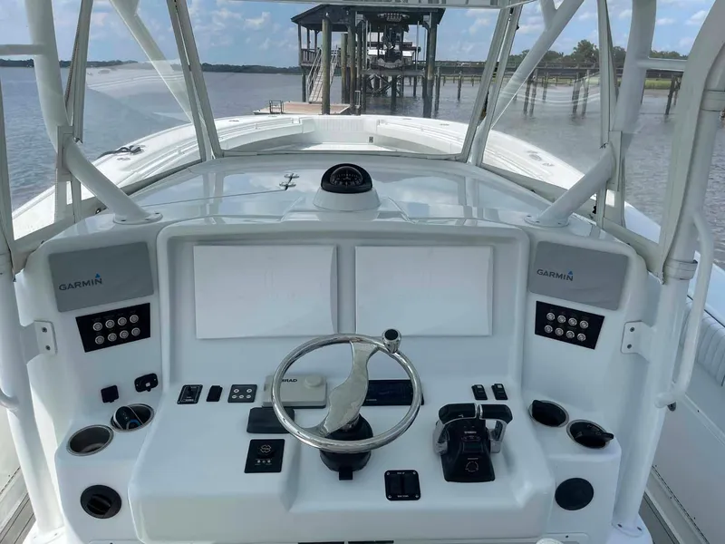 Slide: The Image of 2014 Yellowfin 42 boat helm with Garmin controls, steering wheel, and dual screens. - 13