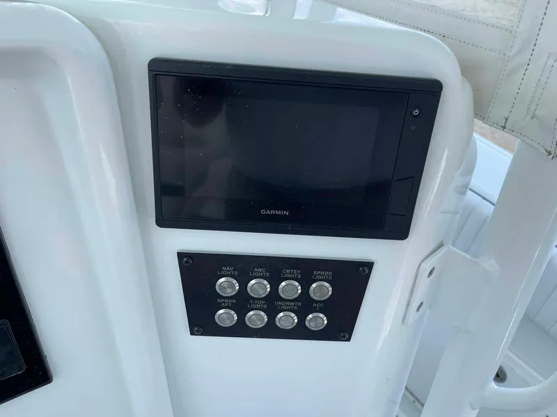 Slide: The Image of Control panel of a 2014 Yellowfin 42 boat with Garmin display and switches. - 14