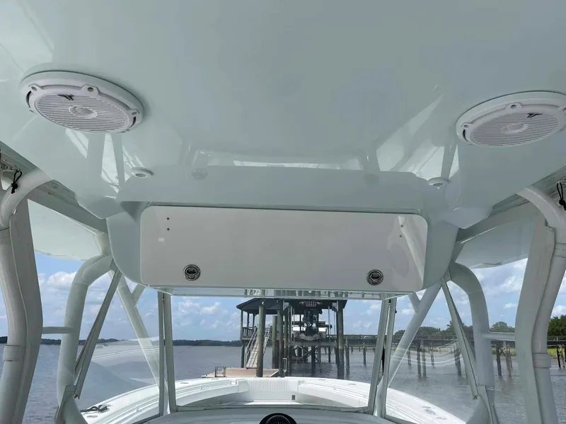 Slide: The Image of 2014 Yellowfin 42 boat interior with speakers and a view of the dock. - 20
