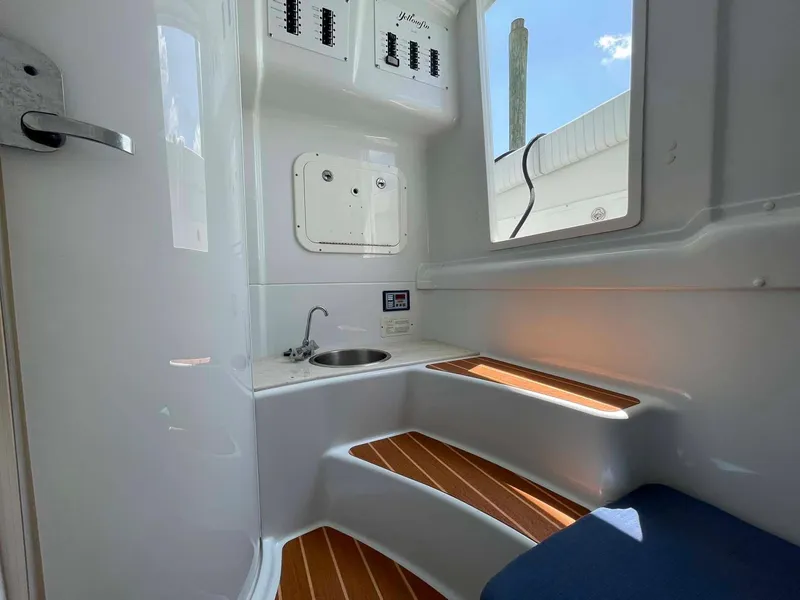 Slide: The Image of Interior of 2014 Yellowfin 42 boat with sink and wooden steps. - 23