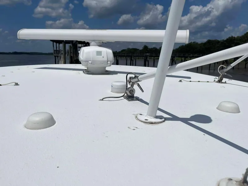 Slide: The Image of 2014 Yellowfin 42 boat deck with radar, under a partly cloudy sky. - 26