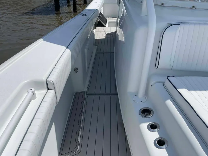 Slide: The Image of 2014 Yellowfin 42 boat interior with sleek white seating and deck design. - 28
