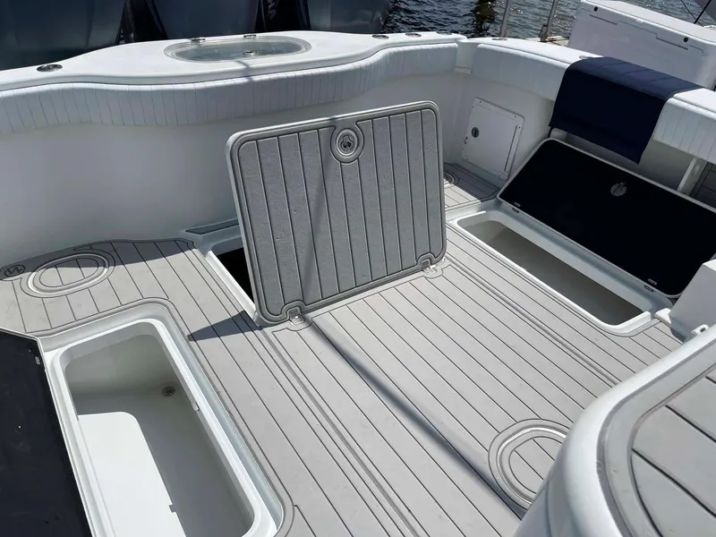 Slide: The Image of 2014 Yellowfin 42 boat deck with open storage compartments and sleek design. - 29