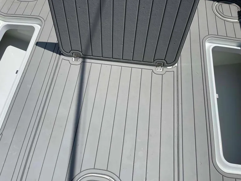 Slide: The Image of 2014 Yellowfin 42 boat deck with storage compartments and non-slip surface. - 32