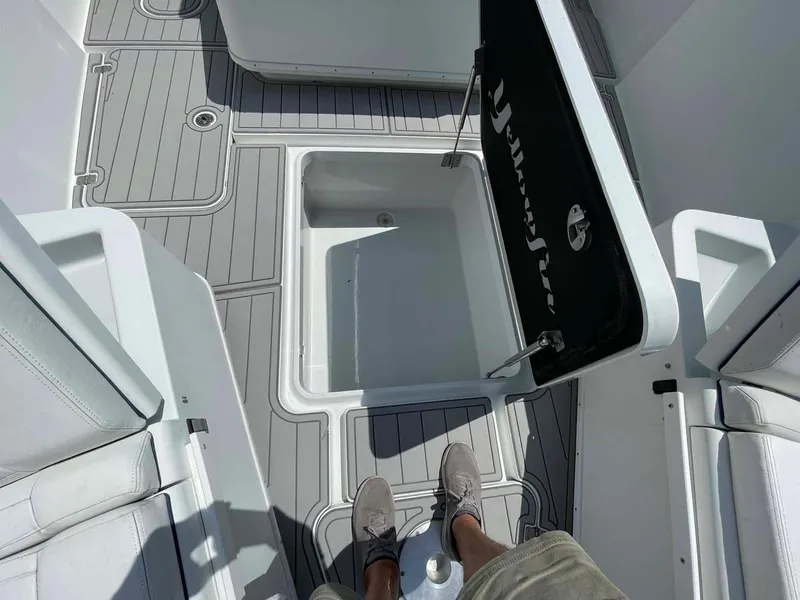 Slide: The Image of 2014 Yellowfin 42 boat deck with open storage compartment, featuring gray non-slip flooring. - 4