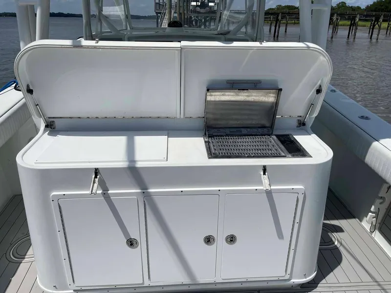 Slide: The Image of 2014 Yellowfin 42 boat with open storage compartments and grill on deck. - 46