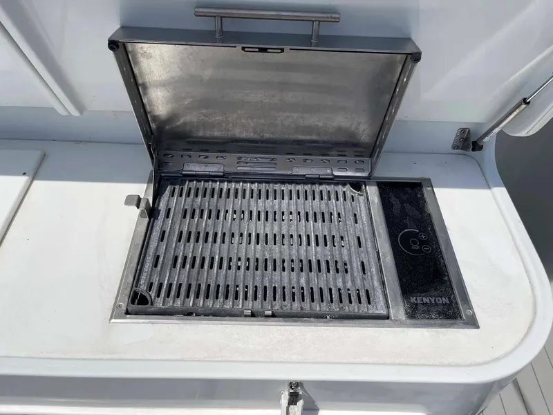 Slide: The Image of Built-in grill on a 2014 Yellowfin 42 boat, featuring a Kenyon cooking surface. - 47