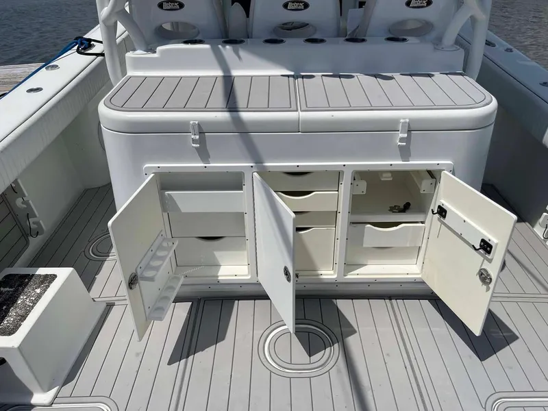Slide: The Image of 2014 Yellowfin 42 boat interior with open storage compartments and seating. - 48