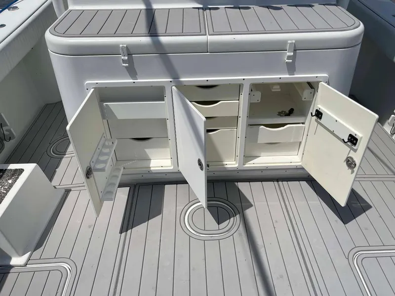 Slide: The Image of 2014 Yellowfin 42 boat storage compartments with open doors on deck. - 49