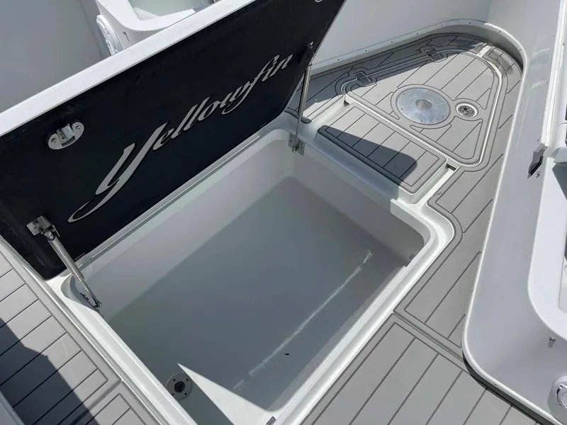 Slide: The Image of 2014 Yellowfin 42 boat storage compartment with open lid, showcasing spacious interior. - 5