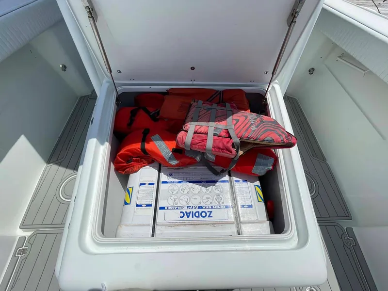 Slide: The Image of Storage compartment on a 2014 Yellowfin 42 boat with life jackets and supplies. - 9