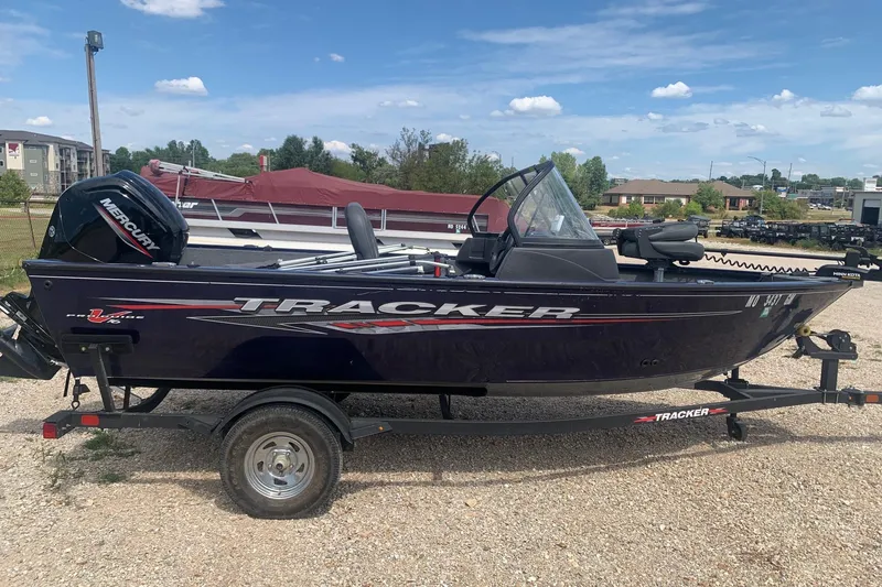Slide: The Image of 2024 Tracker Pro Guide V-16 WT boat on trailer, parked outdoors. - 3