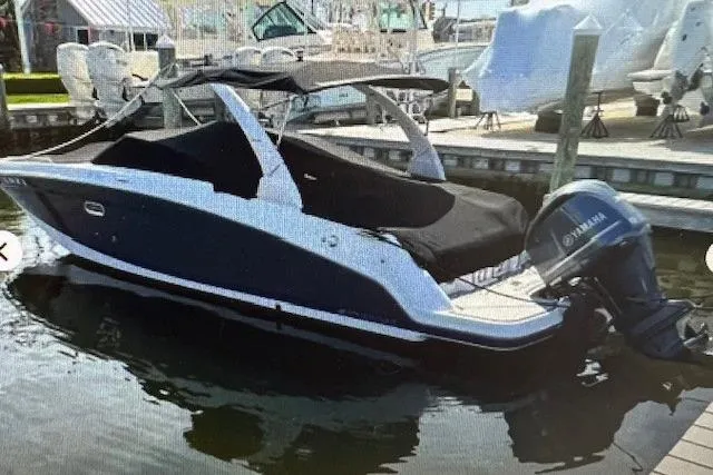 Slide: The Image of 2018 Four Winns HD270 OB boat docked with Yamaha outboard motor. - 2